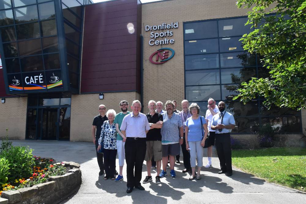 Group of people smiling at camera - stood in front of Dronfield SC